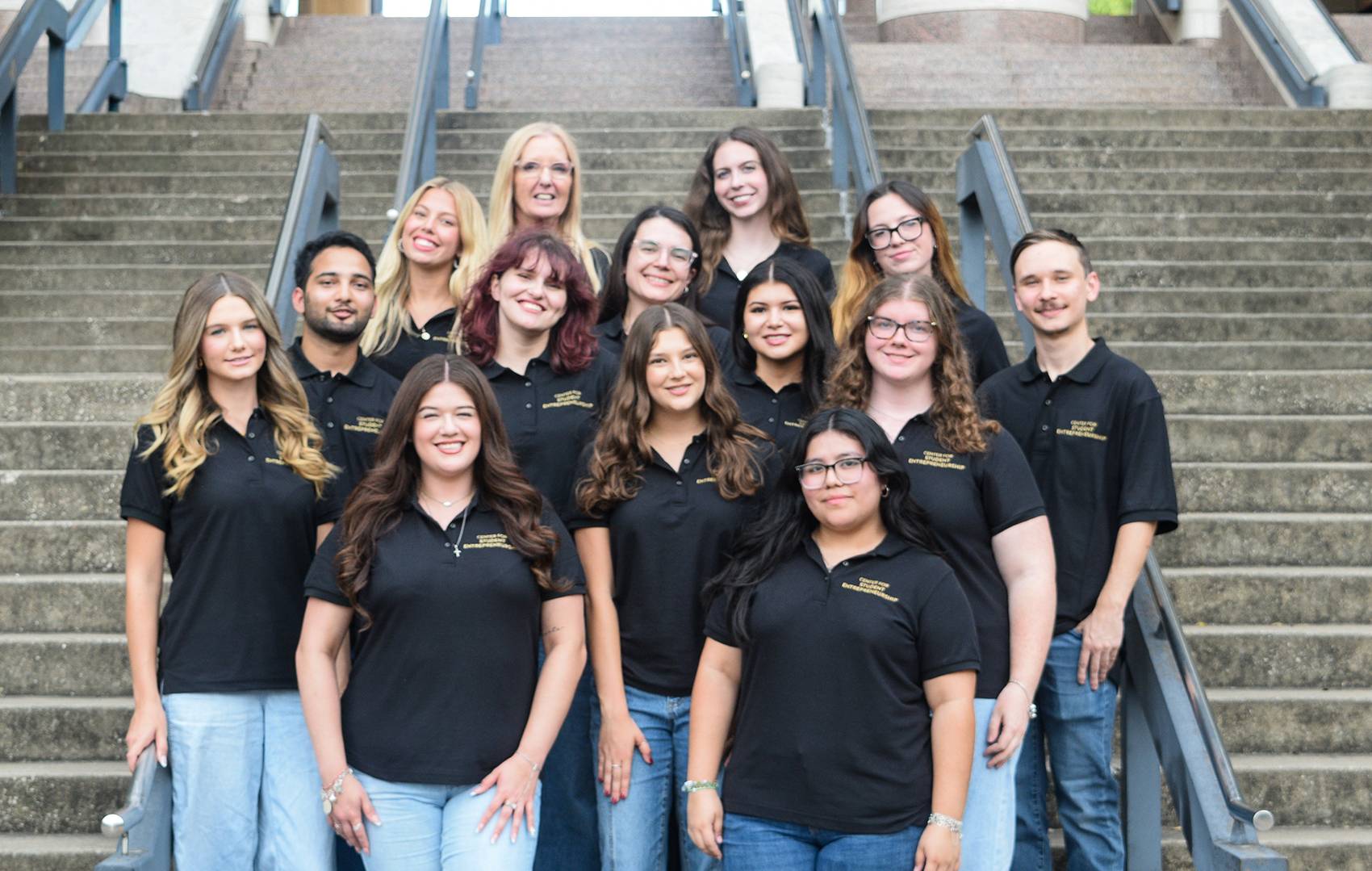 Center for Student Entrepreneurship students and staff pose together on outdoor steps at Texas State University.