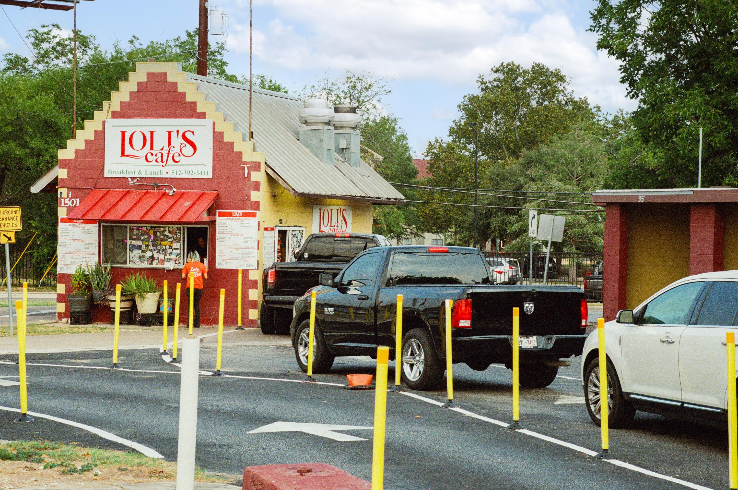 lines of cars line up for drive-thru window for a small red brick building