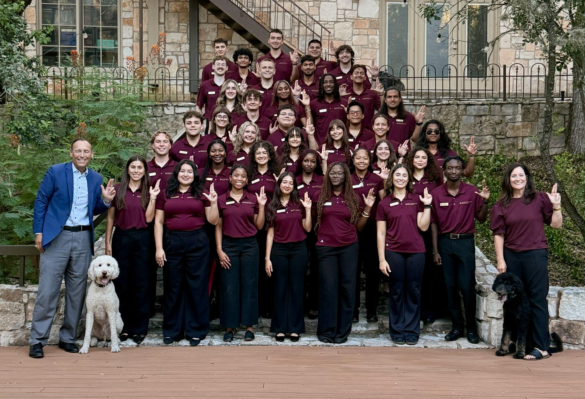 Students post with President and Mrs. Damphousse at their home