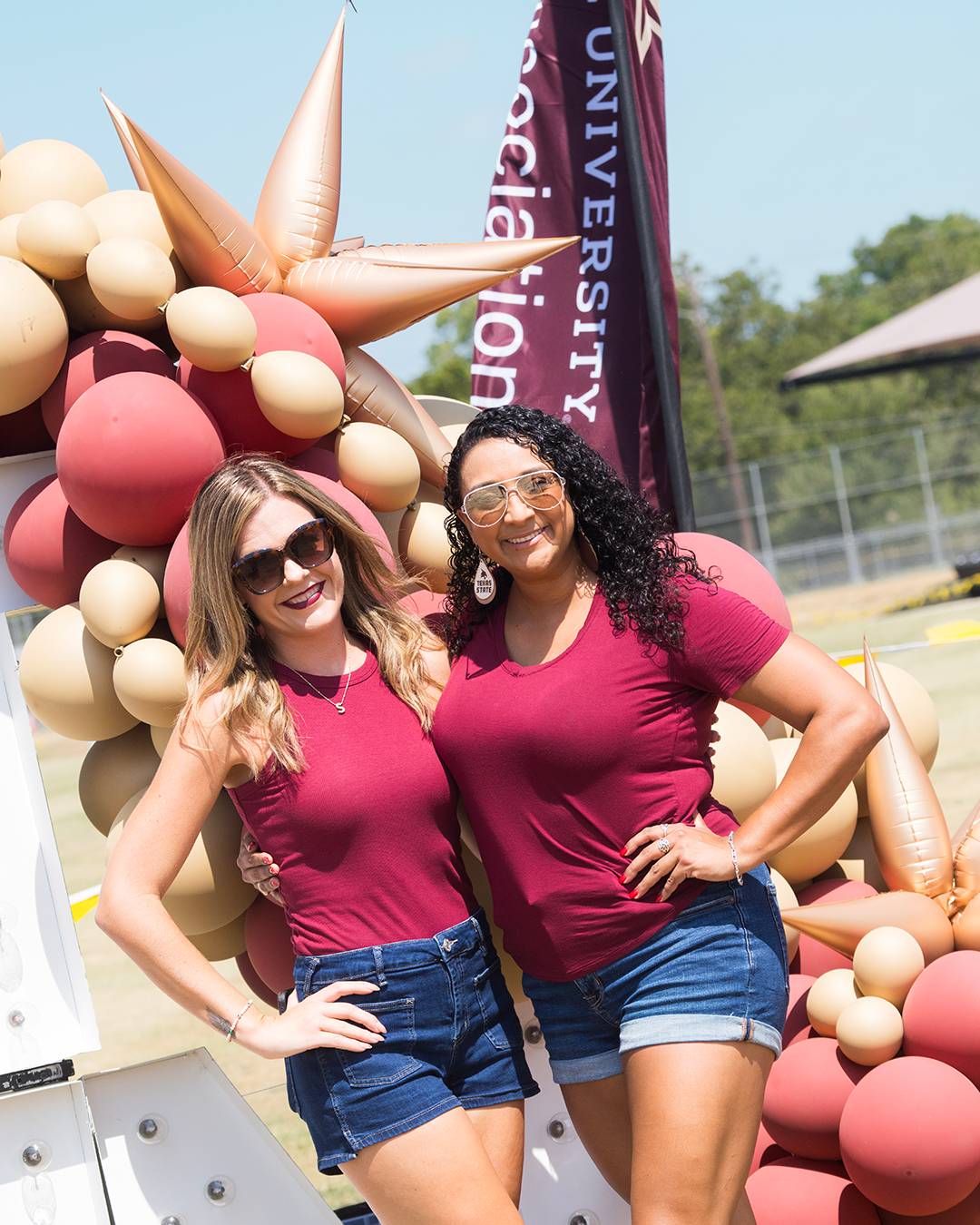Two Texas State fans posing for a photo in Boko's Backyard