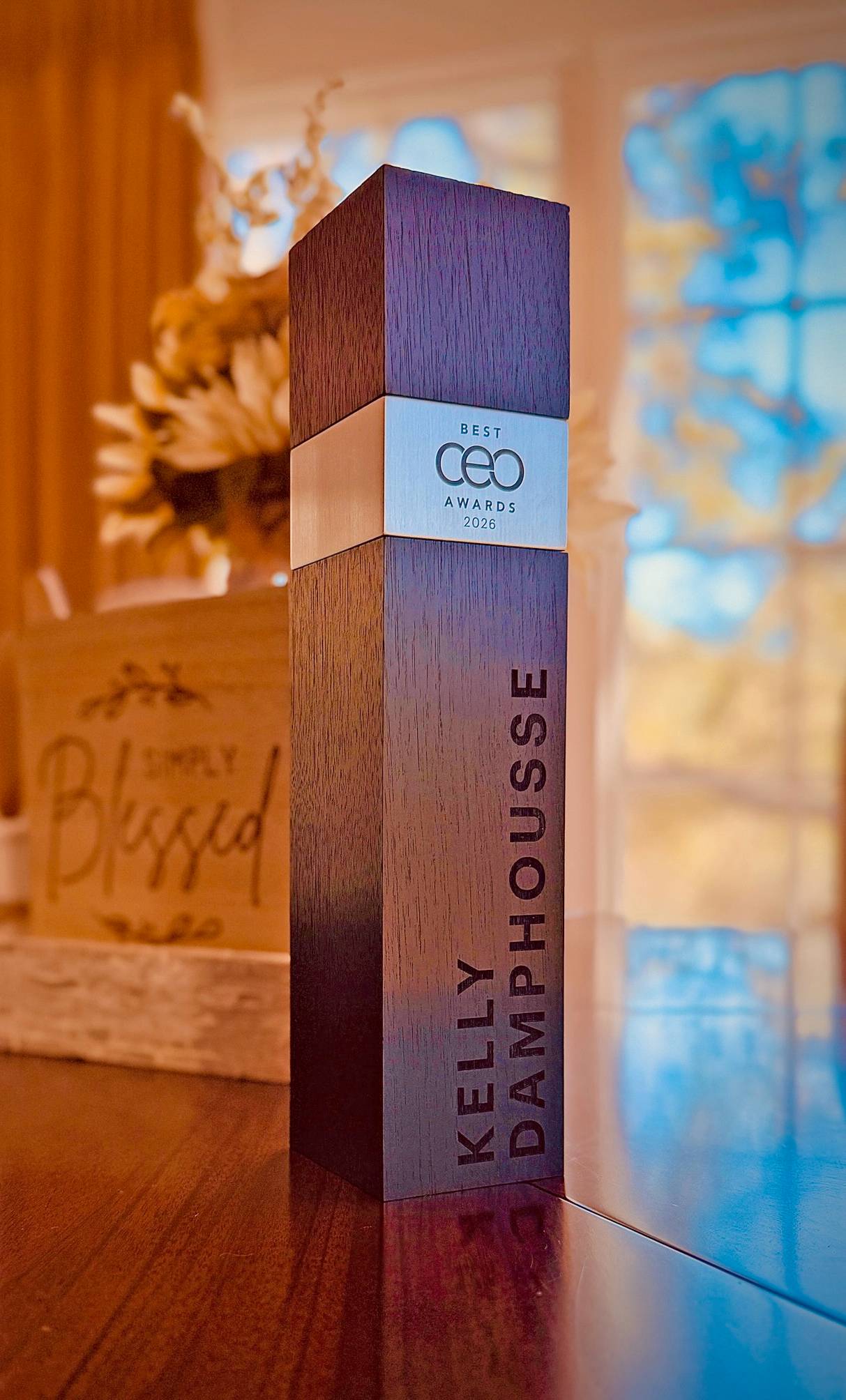 wooden award reading "best ceo awards kelly damphousse"