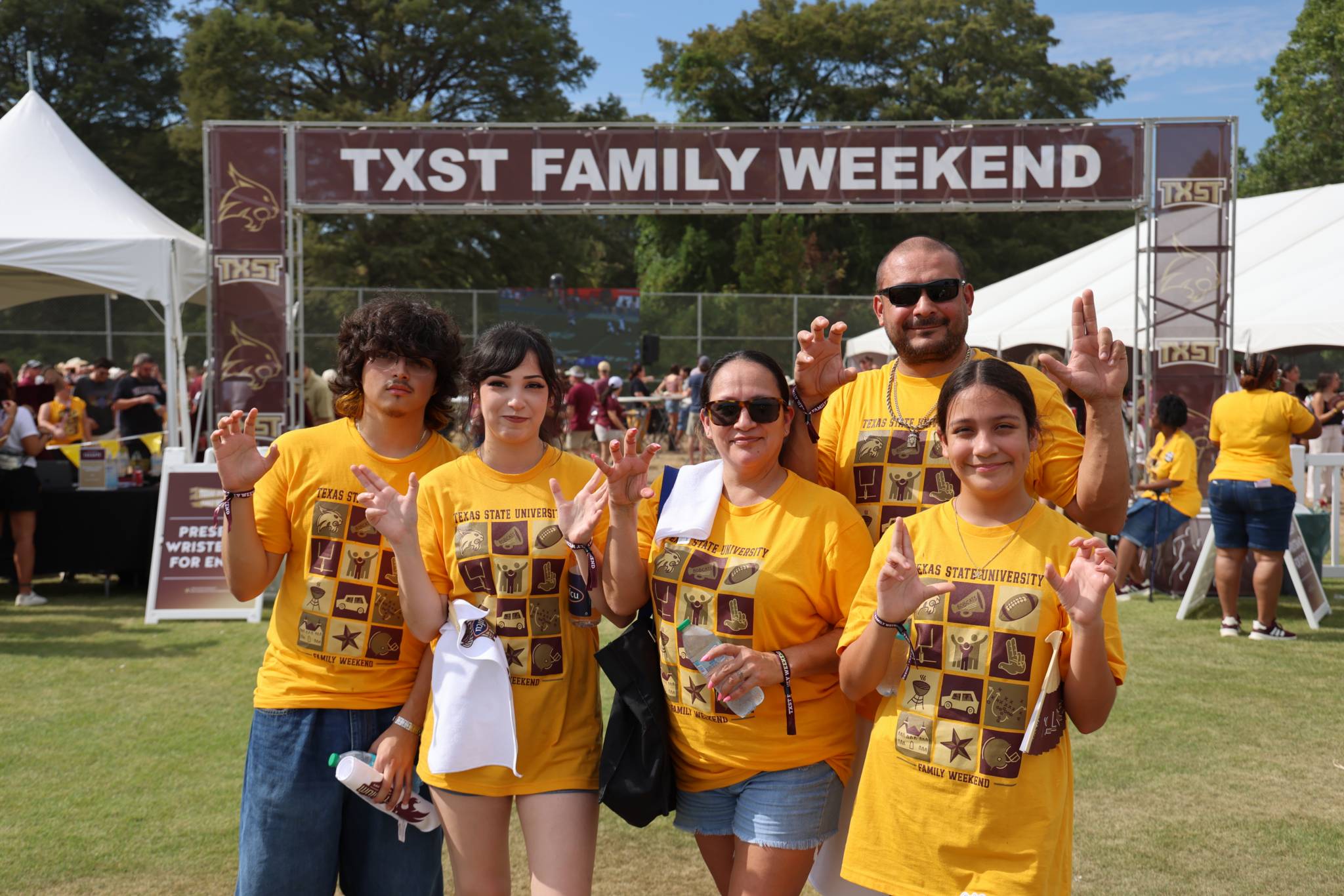 Family in family weekend shirts during tailgate