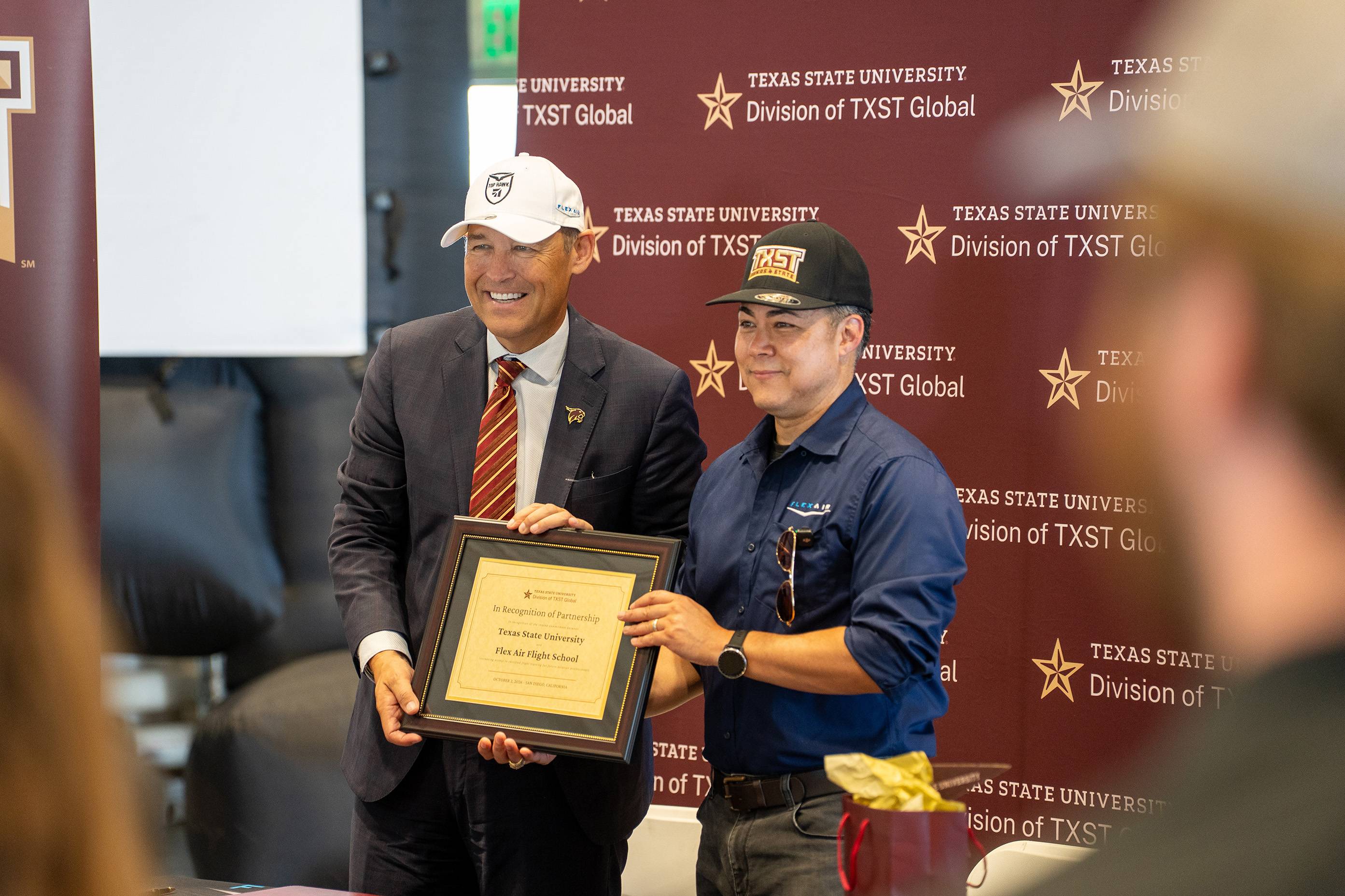 two men holding certificate