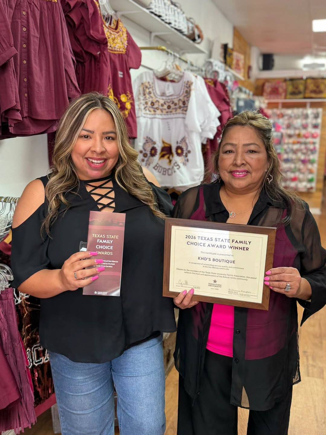 two women holding certificate reading "Family choice award"