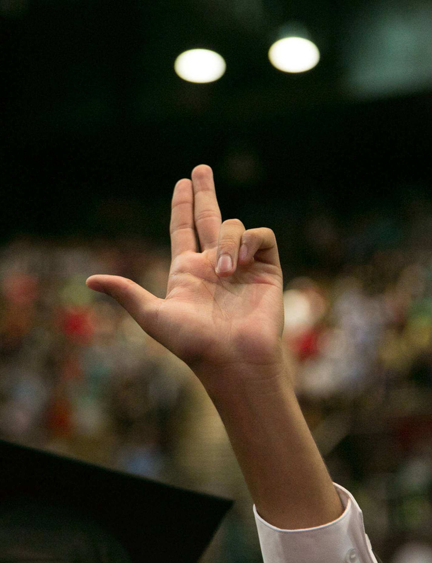 a student holding up the texas state hand gesture