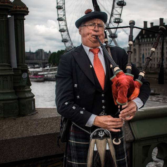 Scotland Man Playing Bagpipes, wearing kilt