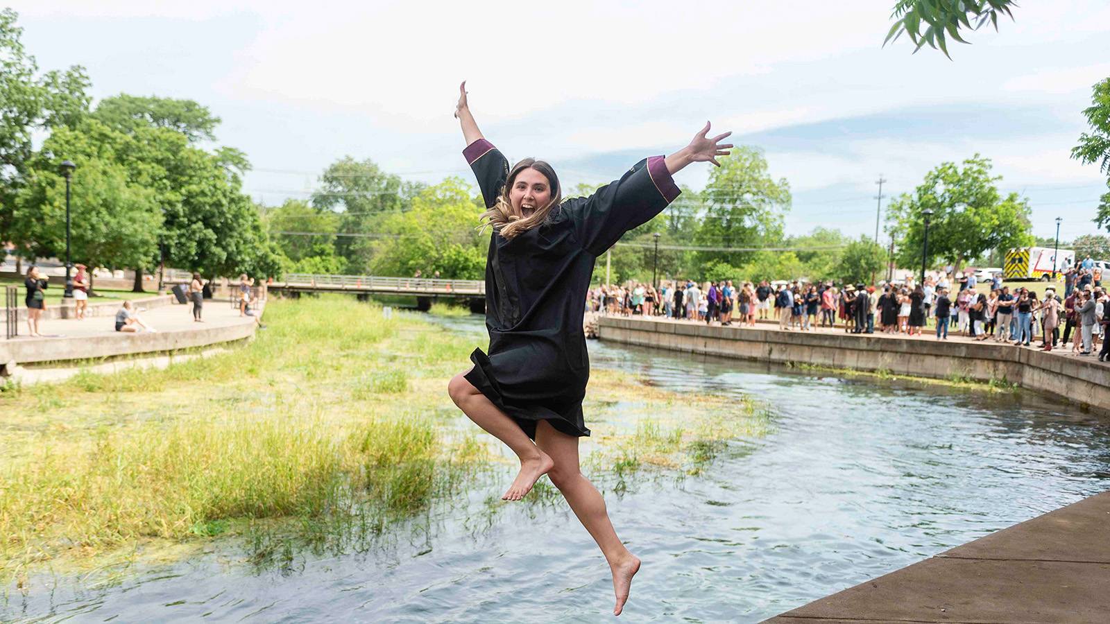 Graduate Jumping into River