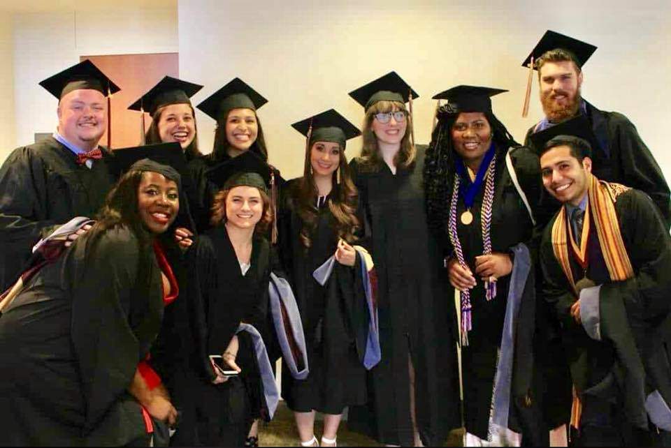 Comm Studies Graduates Celebrating in their graduation robes